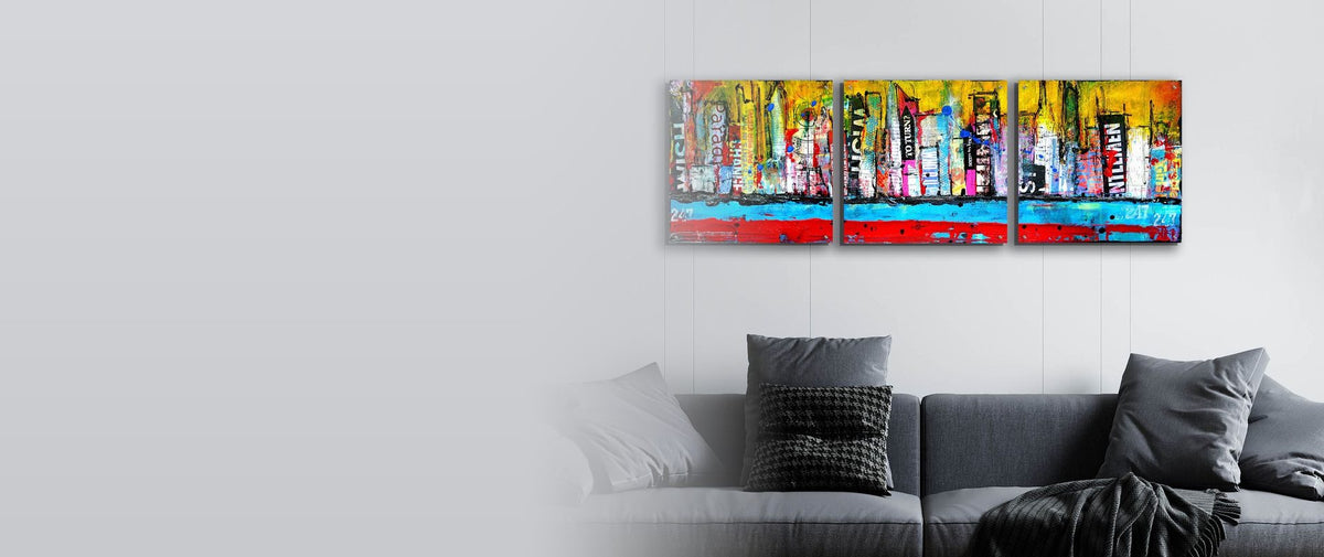 Colorful abstract city skyline triptych in acrylic glass above a grey sofa